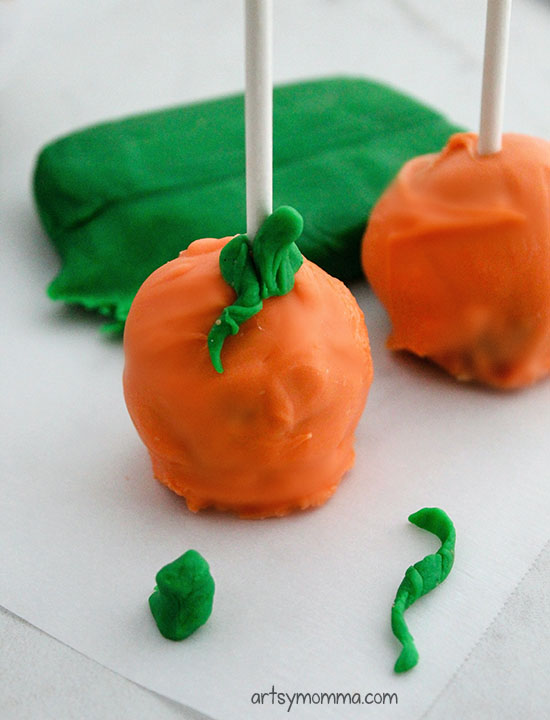 Create a stem and a vine for the pumpkin pops using a small bit of green fondant