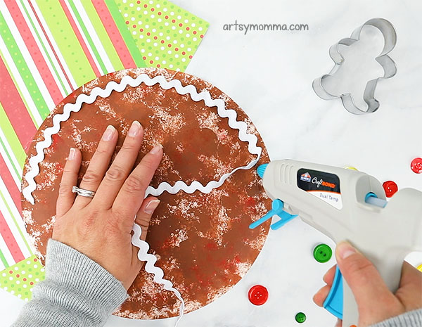 Decorating the paper plate gingerbread man cookie