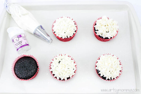 pipe frosting onto cupcakes