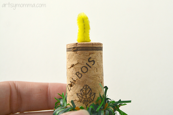 yellow pipe cleaner in wine cork to make candle flame
